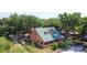 Charming home with a metal roof nestled among lush trees, offering a serene and private living environment at 1850 Orangewood Ave, St Cloud, FL 34772