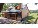 Cozy log cabin featuring a screened-in porch and lush surroundings, ideal for enjoying the peaceful outdoors at 1850 Orangewood Ave, St Cloud, FL 34772