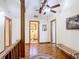 Upstairs hallway features hardwood floors, natural light, and convenient access to multiple rooms at 1850 Orangewood Ave, St Cloud, FL 34772