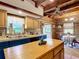 Open kitchen featuring wooden beam ceilings, a center island, and tile countertops at 1850 Orangewood Ave, St Cloud, FL 34772