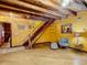 Open living room with wooden beams, staircase, and hardwood floors providing ample space for seating at 1850 Orangewood Ave, St Cloud, FL 34772