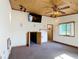 Living room with a wooden ceiling, a large TV, and a cozy, carpeted floor at 1850 Orangewood Ave, St Cloud, FL 34772