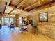 Cozy living area with wood-paneled walls, hardwood floors, and a functional desk area, offering a functional living space at 1850 Orangewood Ave, St Cloud, FL 34772