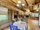 Cozy living room with wood paneling, stone fireplace, and adjacent office space at 1850 Orangewood Ave, St Cloud, FL 34772