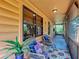 Relaxing screened-in porch with cozy seating, vibrant rugs, and plants, perfect for enjoying the fresh air at 1850 Orangewood Ave, St Cloud, FL 34772