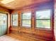 Charming sunroom with wood paneled walls, and views of the backyard at 1850 Orangewood Ave, St Cloud, FL 34772
