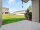 View of green backyard with a satellite dish and housing in the background at 1917 Compass Flower Way, Ocoee, FL 34761