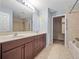 Bathroom features a double sink vanity, soaking tub, and walk-in shower at 1917 Compass Flower Way, Ocoee, FL 34761