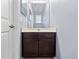 Bathroom with a single vanity, dark wood cabinets, and a white countertop at 1917 Compass Flower Way, Ocoee, FL 34761
