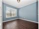 Cozy bedroom featuring hardwood floors and a large window for natural light at 1917 Compass Flower Way, Ocoee, FL 34761