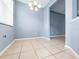 Bright dining area showcasing neutral walls, tile flooring, and partial view of the adjacent living room at 1917 Compass Flower Way, Ocoee, FL 34761