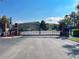 View of the community entrance gate on a sunny day, ensuring privacy and security at 1917 Compass Flower Way, Ocoee, FL 34761