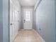 Clean and bright entryway featuring neutral tile flooring and a white front door at 1917 Compass Flower Way, Ocoee, FL 34761