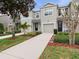 Inviting townhome exterior with well-maintained landscaping and a private driveway at 1917 Compass Flower Way, Ocoee, FL 34761