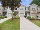 Inviting townhome exterior with well-maintained landscaping and a private driveway at 1917 Compass Flower Way, Ocoee, FL 34761