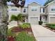 Inviting townhome exterior with well-maintained landscaping and a private driveway at 1917 Compass Flower Way, Ocoee, FL 34761