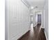 Hallway with hardwood floors and access to multiple rooms at 1917 Compass Flower Way, Ocoee, FL 34761