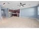Open-concept living room and kitchen with stainless appliances, cherry cabinets, and modern lighting at 1917 Compass Flower Way, Ocoee, FL 34761