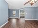 Bright living room features hardwood floors, large windows, and neutral paint at 1917 Compass Flower Way, Ocoee, FL 34761