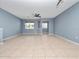 Spacious living area features neutral walls, tile flooring and a ceiling fan for comfort at 1917 Compass Flower Way, Ocoee, FL 34761