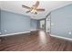 Open living room with hardwood floors, ceiling fan, and natural light at 1917 Compass Flower Way, Ocoee, FL 34761