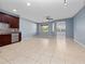 Open-concept living room features neutral paint, ceiling fan and access to the kitchen and dining areas at 1917 Compass Flower Way, Ocoee, FL 34761