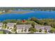 Aerial view of townhomes near a serene lake, highlighted by a red pin at 1936 Compass Flower Way, Ocoee, FL 34761