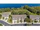 Aerial shot features modern townhomes nestled within a lush, lakeside community at 1936 Compass Flower Way, Ocoee, FL 34761