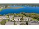 Panoramic aerial view of townhomes adjacent to a picturesque lake at 1936 Compass Flower Way, Ocoee, FL 34761
