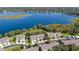Stunning aerial view of modern townhomes beside a vast, tranquil lake at 1936 Compass Flower Way, Ocoee, FL 34761