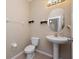 Cozy half bathroom featuring a pedestal sink, modern fixtures, and neutral tones at 1936 Compass Flower Way, Ocoee, FL 34761