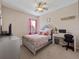 Cozy bedroom featuring plush decor, a decorative bed frame, and an inviting ambiance at 1936 Compass Flower Way, Ocoee, FL 34761