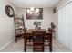 Cozy dining room featuring a wooden table set, decorative art, and stylish lighting at 1936 Compass Flower Way, Ocoee, FL 34761