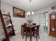 Bright dining area featuring a wooden table set, stylish decor, and natural light at 1936 Compass Flower Way, Ocoee, FL 34761
