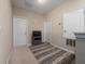 Comfortable hallway with a TV set, three doors, neutral paint and a cozy rug at 1936 Compass Flower Way, Ocoee, FL 34761