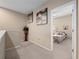 Light and bright hallway with plant decoration leading to a bedroom with carpet flooring at 1936 Compass Flower Way, Ocoee, FL 34761