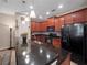 Modern kitchen featuring dark granite countertops, stainless steel sink, and dark wood cabinetry at 1936 Compass Flower Way, Ocoee, FL 34761