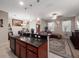 Open-concept kitchen with granite countertops, and seamless flow into the living and dining areas at 1936 Compass Flower Way, Ocoee, FL 34761