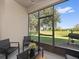 Screened patio with outdoor furniture overlooking a green lawn with lake views at 1936 Compass Flower Way, Ocoee, FL 34761