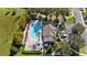 Aerial view of a community pool with lounge chairs and meticulous landscaping at 1936 Compass Flower Way, Ocoee, FL 34761