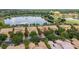 Aerial view showcasing community homes with lake, golf course, and lush landscaping at 2376 Palm Tree Dr, Kissimmee, FL 34759