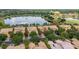 Aerial view showcasing community homes with lake, golf course, and lush landscaping at 2376 Palm Tree Dr, Kissimmee, FL 34759