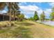 Spacious lawn leading to a serene lake, enhancing the property's appeal at 2376 Palm Tree Dr, Kissimmee, FL 34759