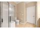 Bathroom featuring a glass enclosed shower, toilet, and doorway at 2376 Palm Tree Dr, Kissimmee, FL 34759