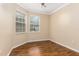 Inviting bedroom featuring wood floors, two windows and neutral wall paint at 2376 Palm Tree Dr, Kissimmee, FL 34759
