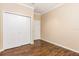 Bedroom featuring wood floors, a double door closet and neutral paint at 2376 Palm Tree Dr, Kissimmee, FL 34759