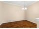 A dining room featuring wood floors, crown molding, a chandelier, and neutral paint at 2376 Palm Tree Dr, Kissimmee, FL 34759
