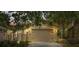 A single-Gathering home featuring an attached two-car garage and a stone-paved driveway, with lovely trees providing shade at 2376 Palm Tree Dr, Kissimmee, FL 34759