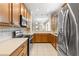 A well-equipped kitchen with stainless steel appliances, wooden cabinets, and a view of the living area, perfect for entertaining at 2376 Palm Tree Dr, Kissimmee, FL 34759