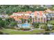 An aerial view of a beautiful clubhouse with a pool and lush landscaping at 2376 Palm Tree Dr, Kissimmee, FL 34759